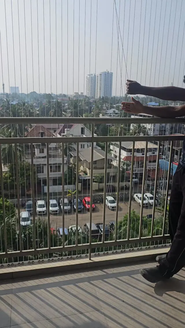 Technician installing an invisible balcony grill